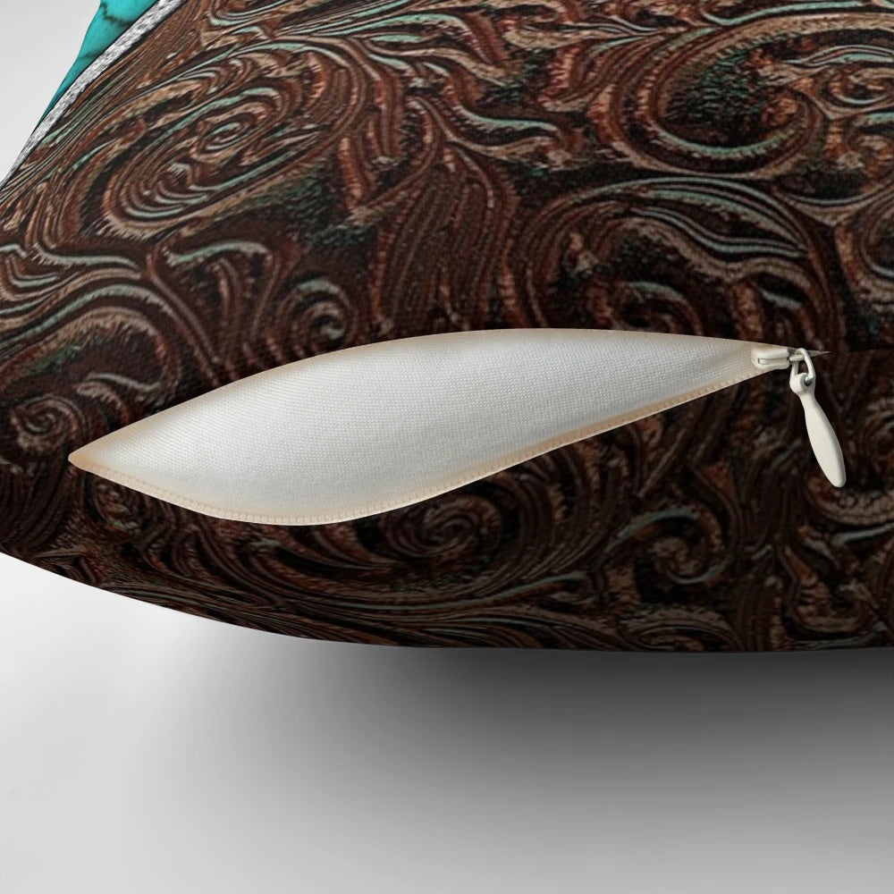 Cowhide and tooled leather pillow with a western cowgirl pattern in turquoise and brown tones