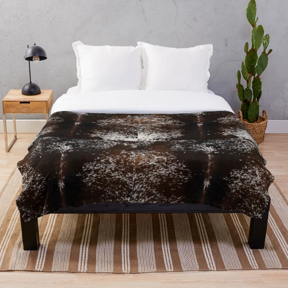 Cowhide-patterned plush blanket for rustic, farmhouse, or western-inspired home decor