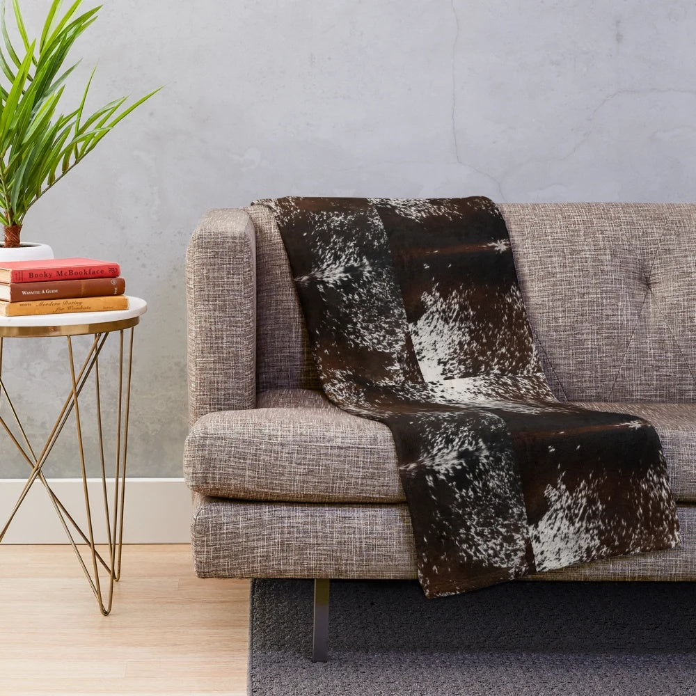 Cowhide-patterned plush blanket for rustic, farmhouse, or western-inspired home decor