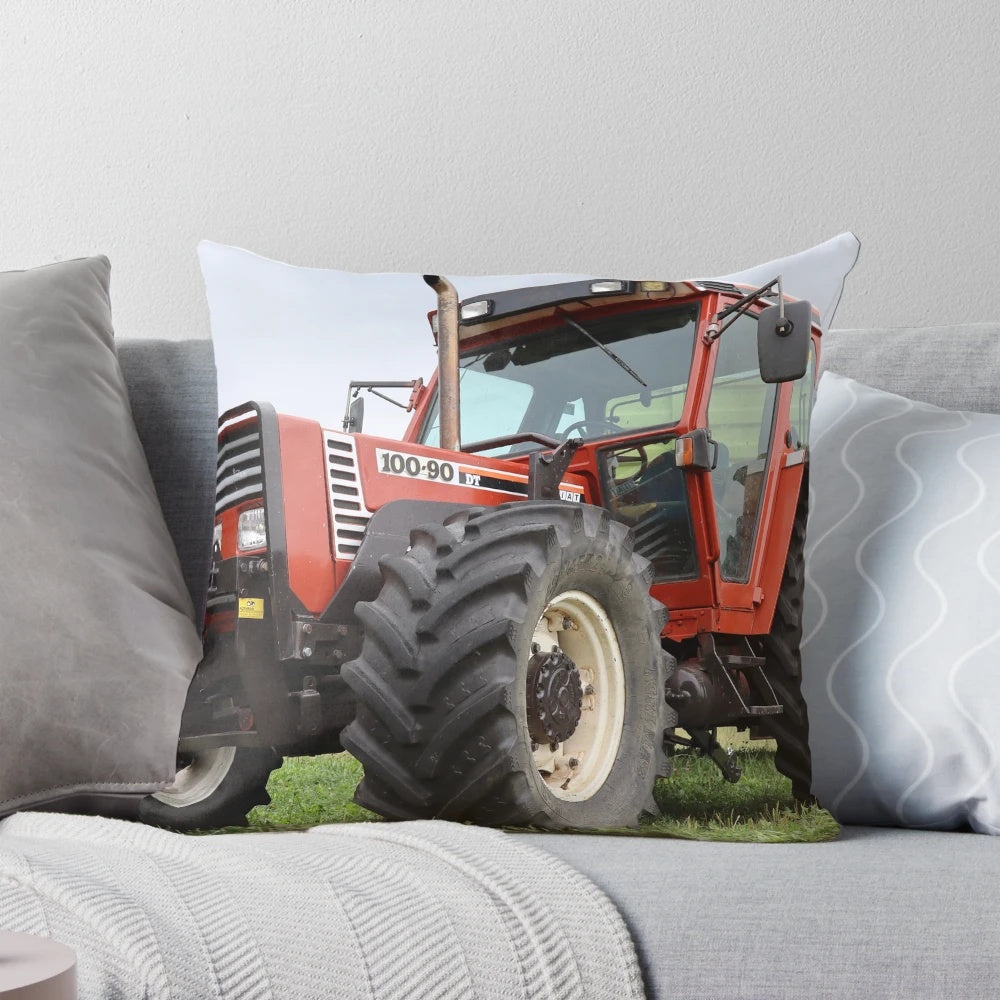 A plush pillow featuring a stylized design of a Fiat 100-90 agricultural tractor