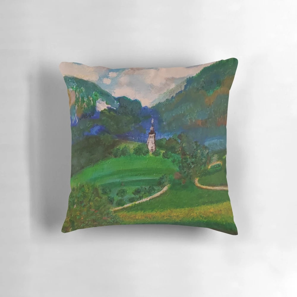 A plush, decorative pillow featuring a charming French countryside landscape with a blue tower, fluffy clouds, and lush greenery.