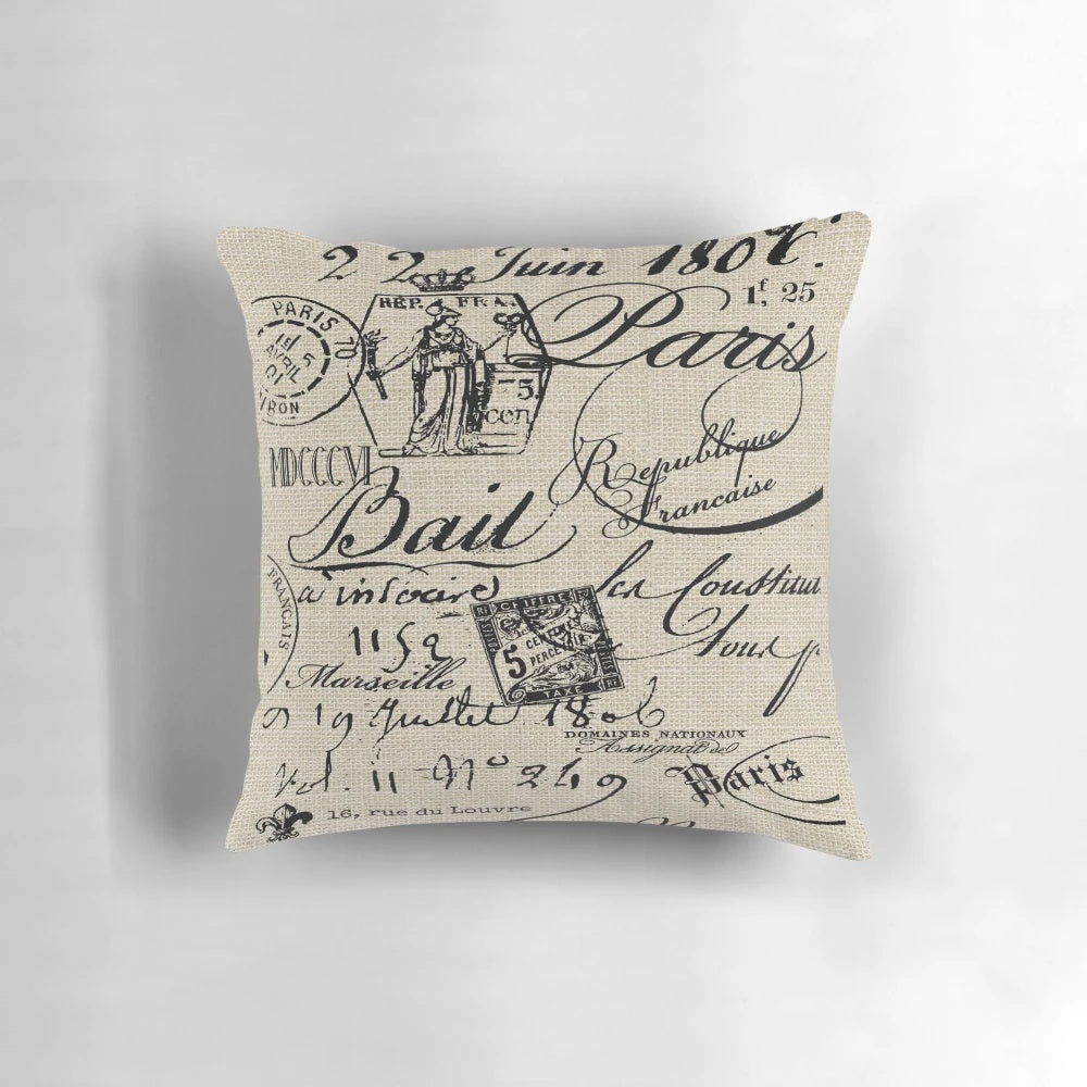 A neutral-colored decorative throw pillow with a handwritten French script design, perfect for adding a touch of vintage charm to any space.
