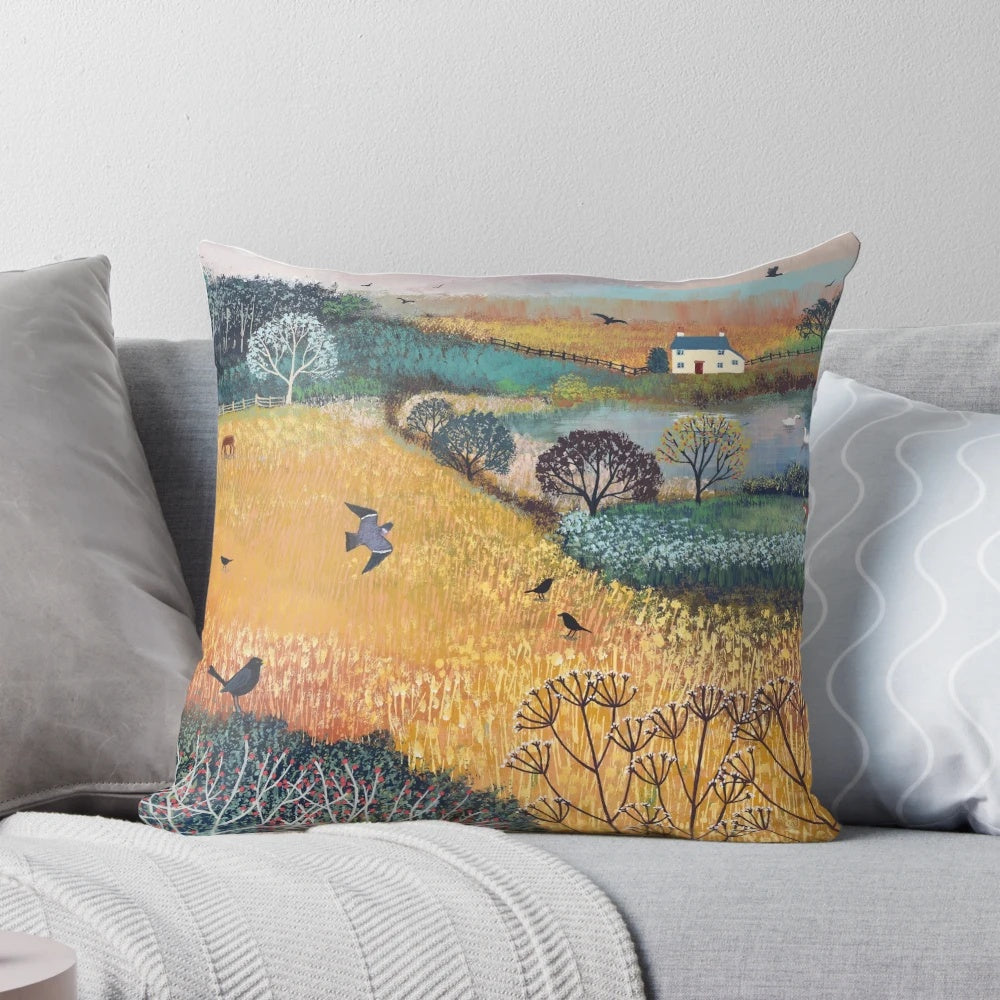 Harvest landscape pillow featuring cottages, birds, and wildlife in a golden countryside scene