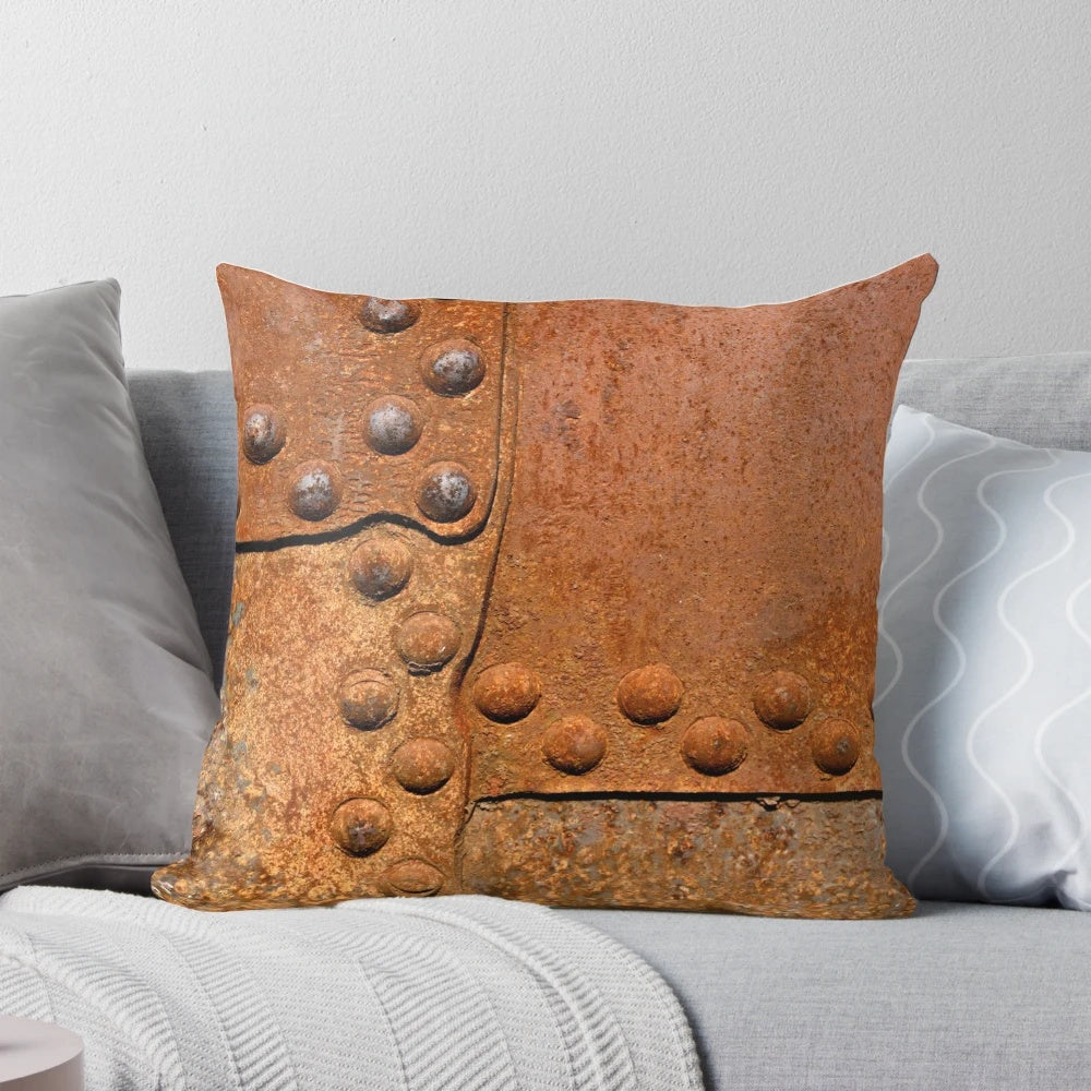 Pillow featuring a distressed, rusty metal surface with riveted joints