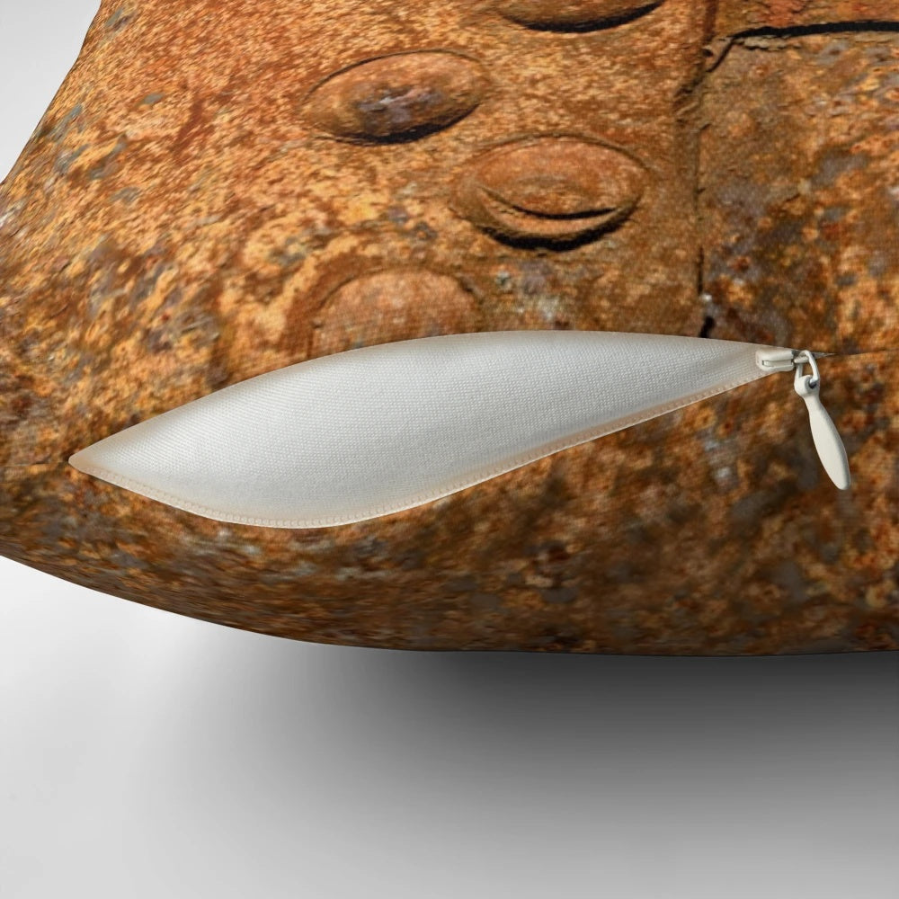 Pillow featuring a distressed, rusty metal surface with riveted joints