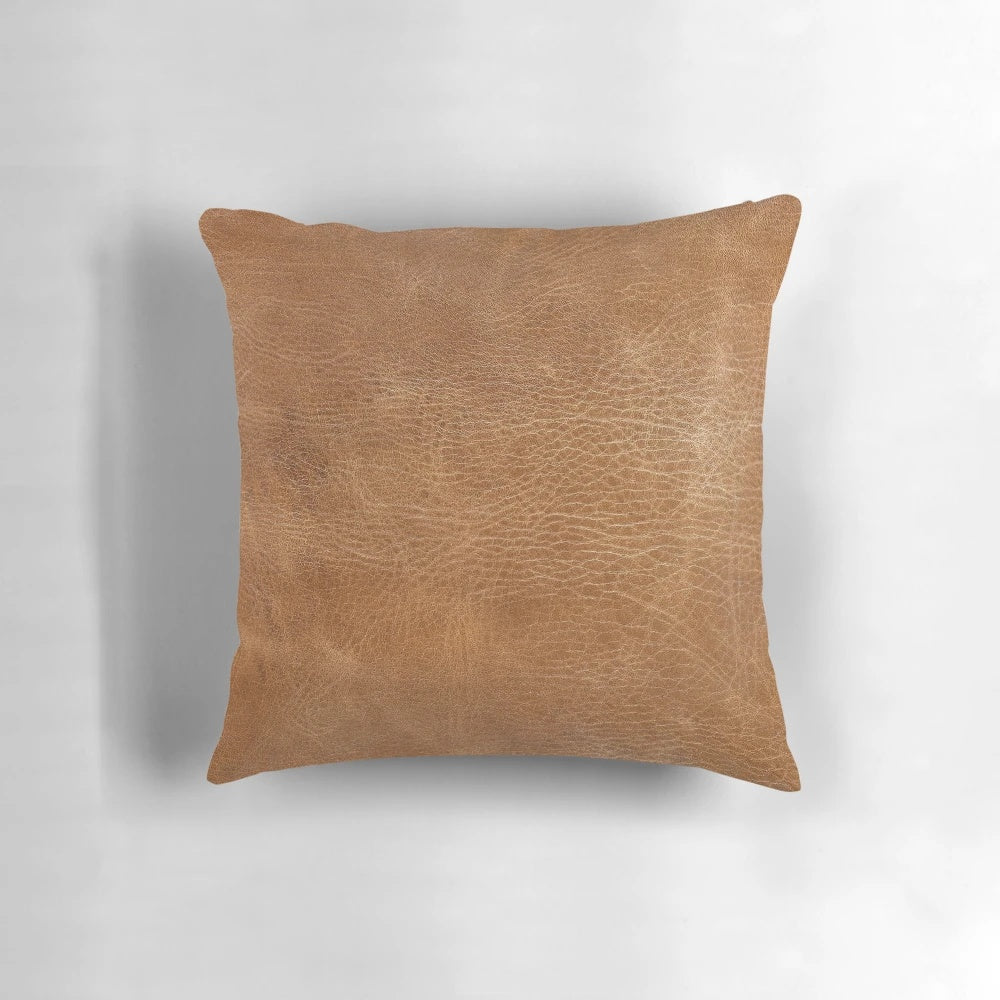 Rustic light brown leather pillow with tooled design, suitable for farmhouse, country, or western-inspired home decor.