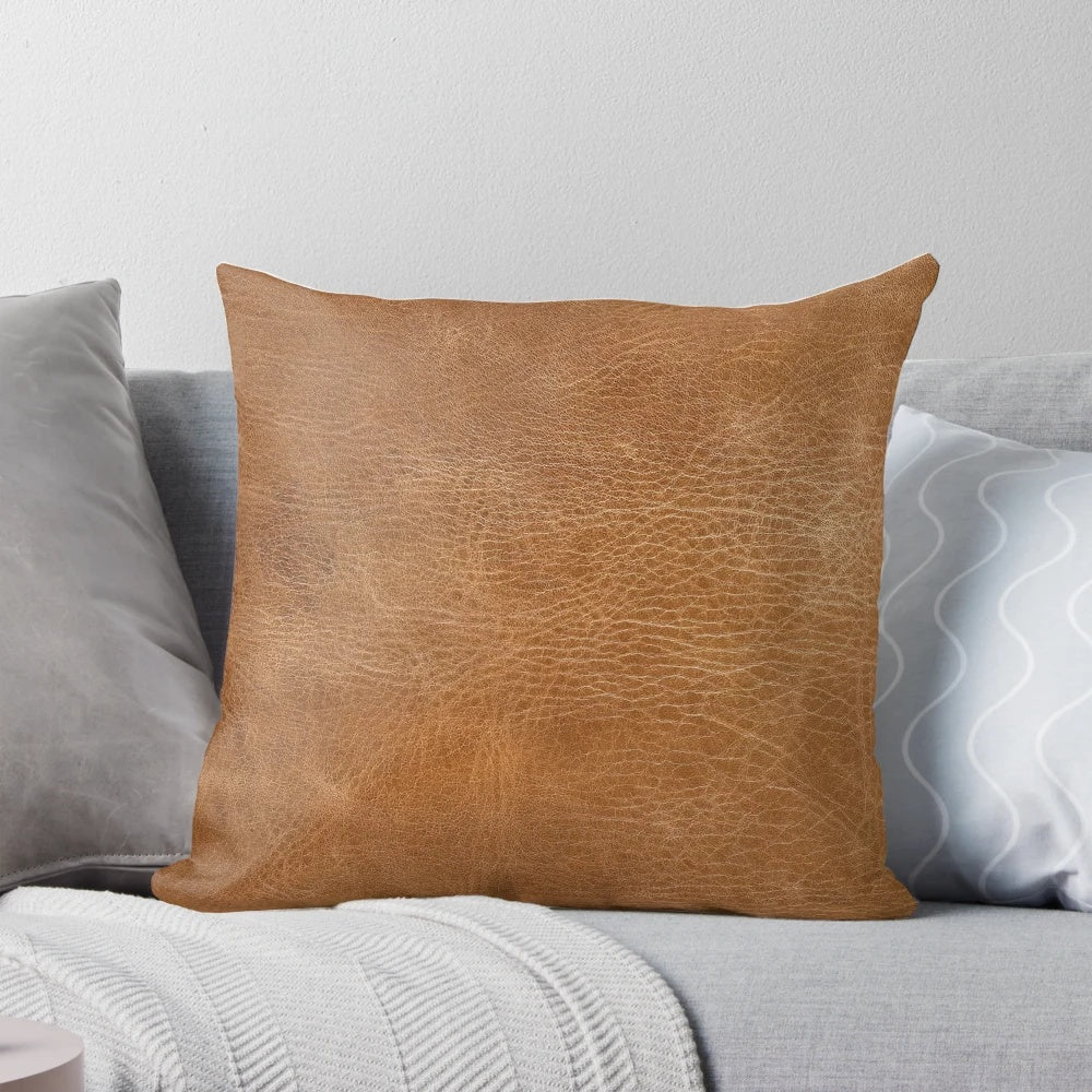 Rustic light brown leather pillow with tooled design, suitable for farmhouse, country, or western-inspired home decor.