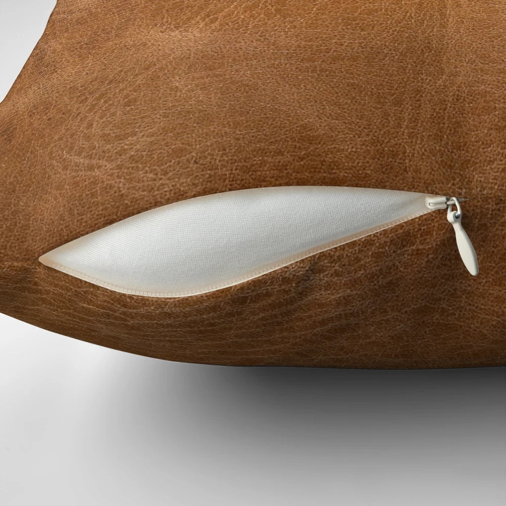 Rustic light brown leather pillow with tooled design, suitable for farmhouse, country, or western-inspired home decor.
