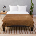 Cozy leather-inspired plush blanket with a vintage, southwestern-inspired design