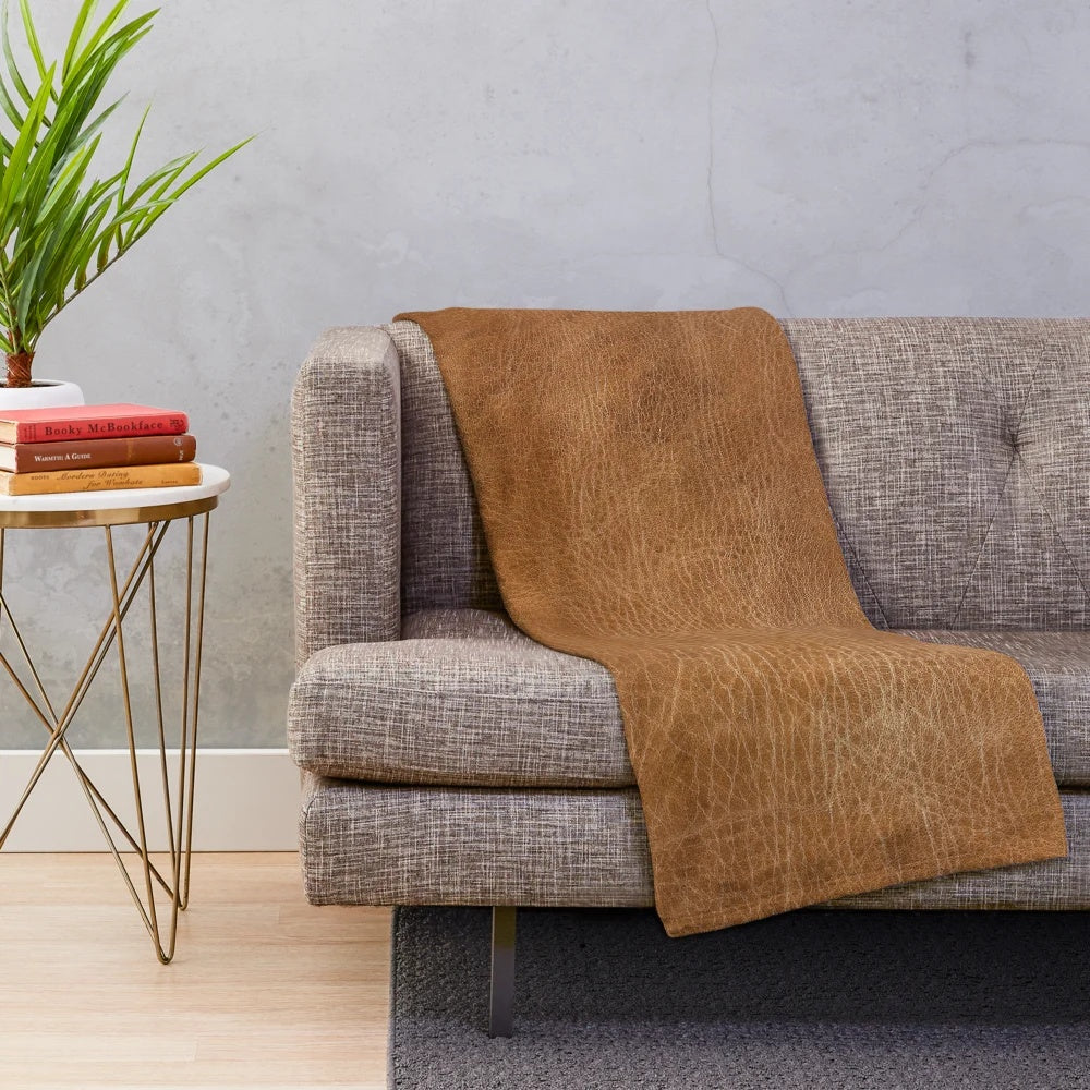 Cozy leather-inspired plush blanket with a vintage, southwestern-inspired design