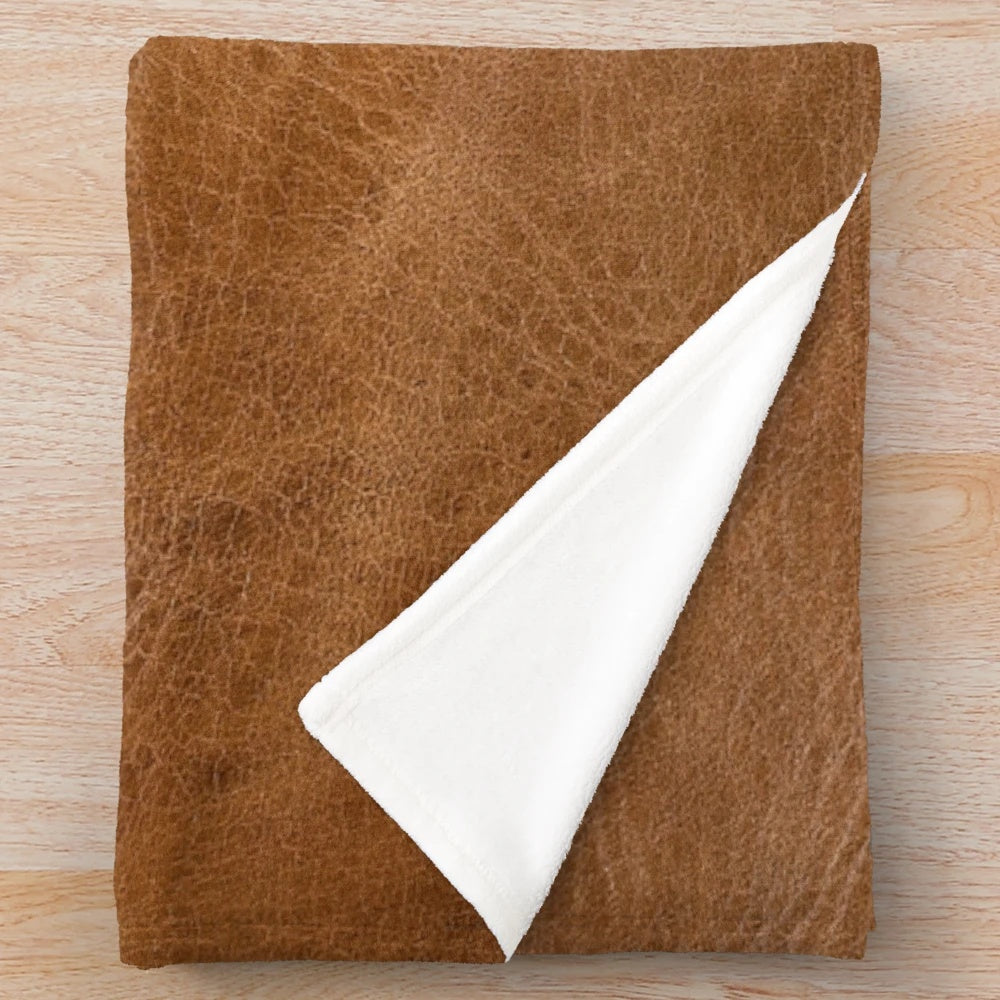 Cozy leather-inspired plush blanket with a vintage, southwestern-inspired design