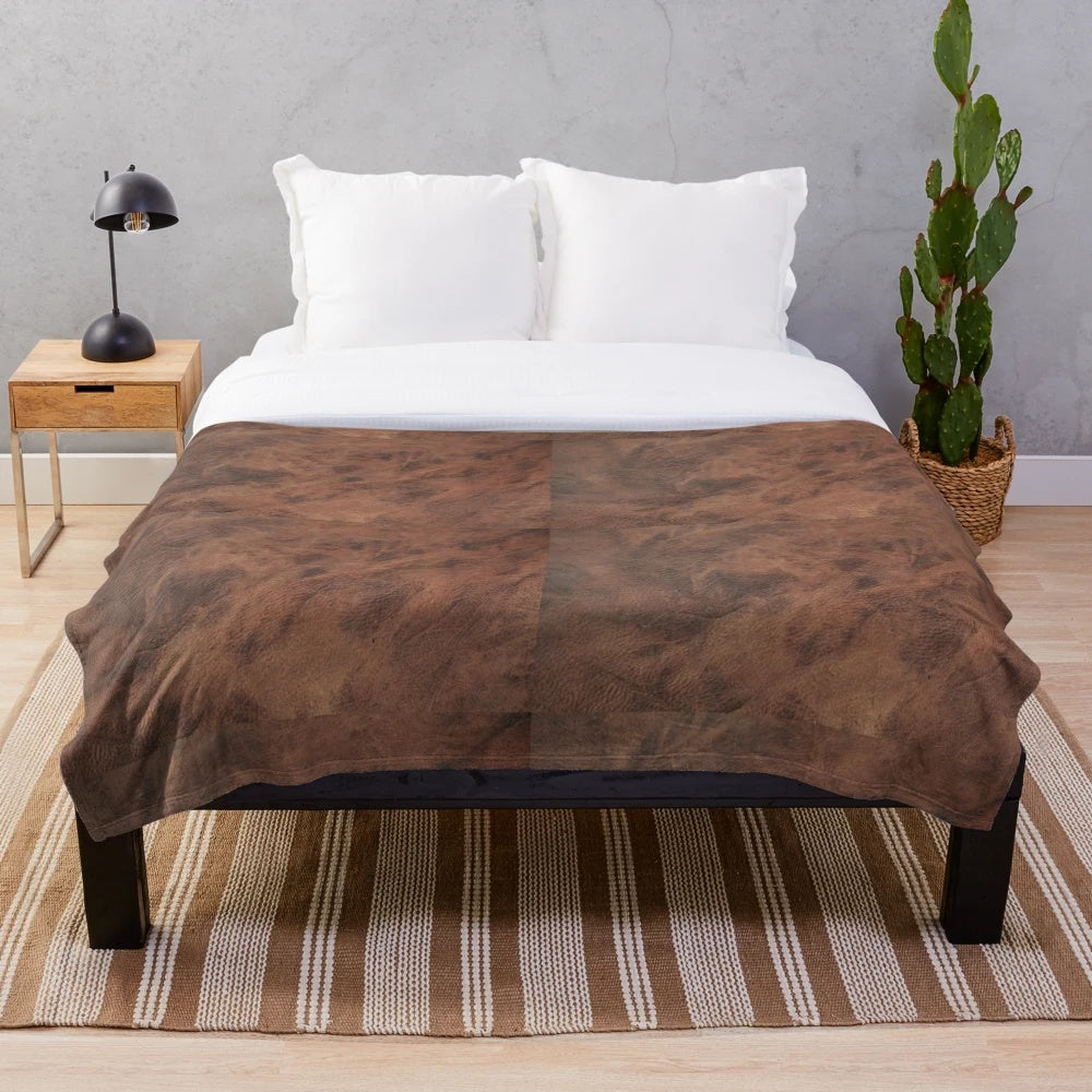 Brown leather-look plush blanket with a cowhide design