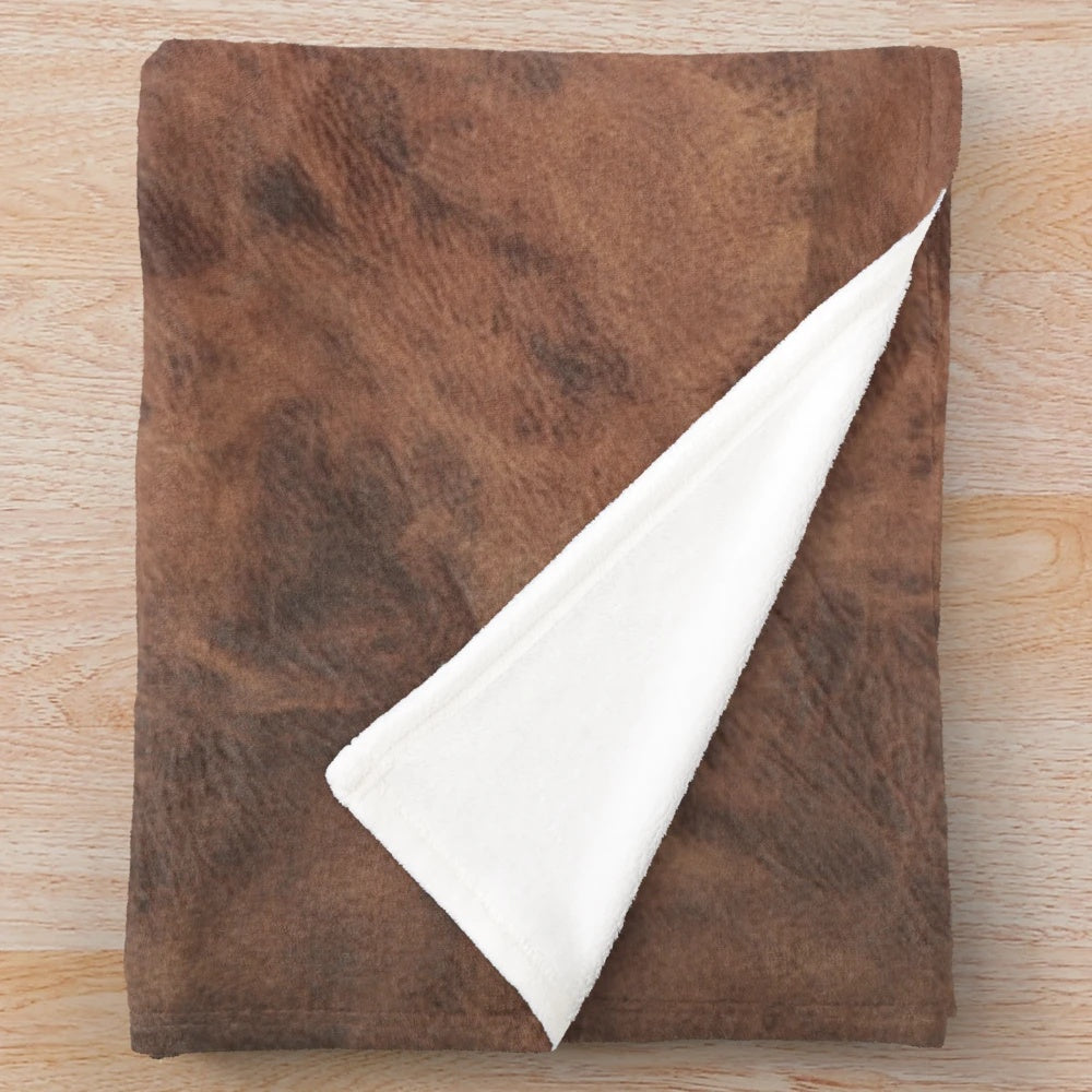 Brown leather-look plush blanket with a cowhide design