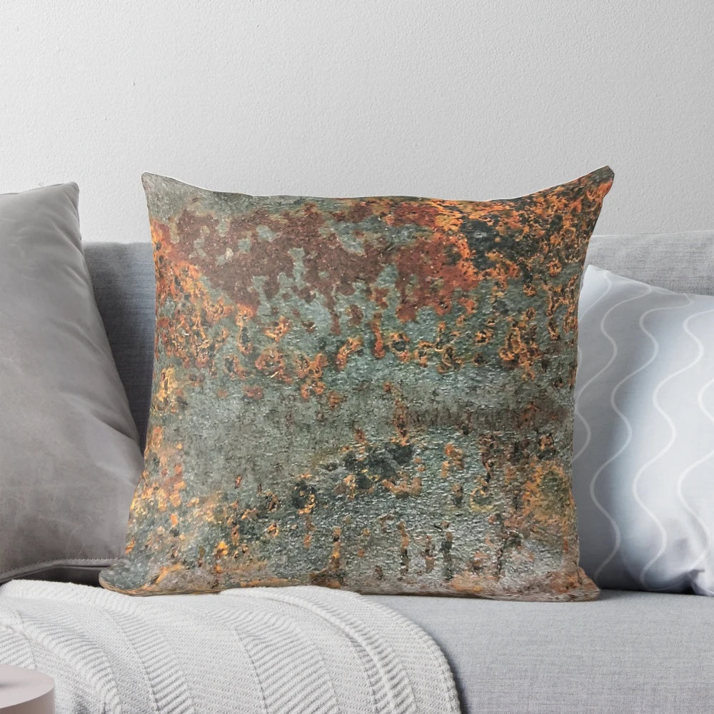 A rusty, metallic pillow with a textured, grungy appearance, perfect for industrial-style home decor.