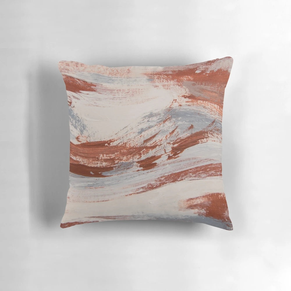 Rustic metallic pillow with oxidized, earthy tones in shades of rust, slate, and white
