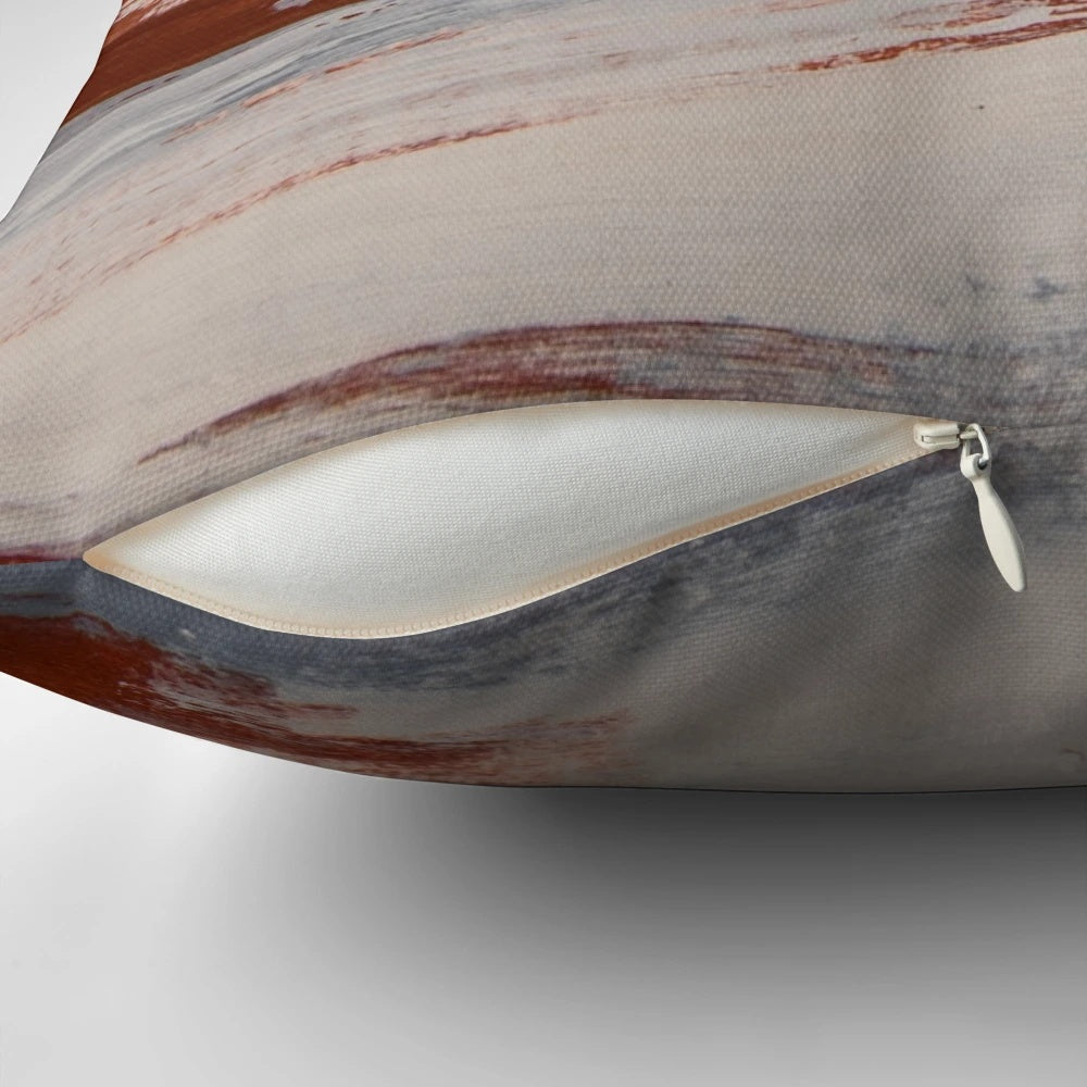 Rustic metallic pillow with oxidized, earthy tones in shades of rust, slate, and white