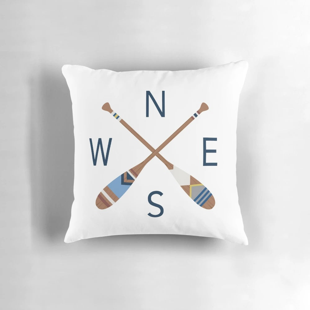 Rustic nautical compass and oar design printed on a cozy throw pillow, perfect for lake house, coastal, and boho-inspired home decor.