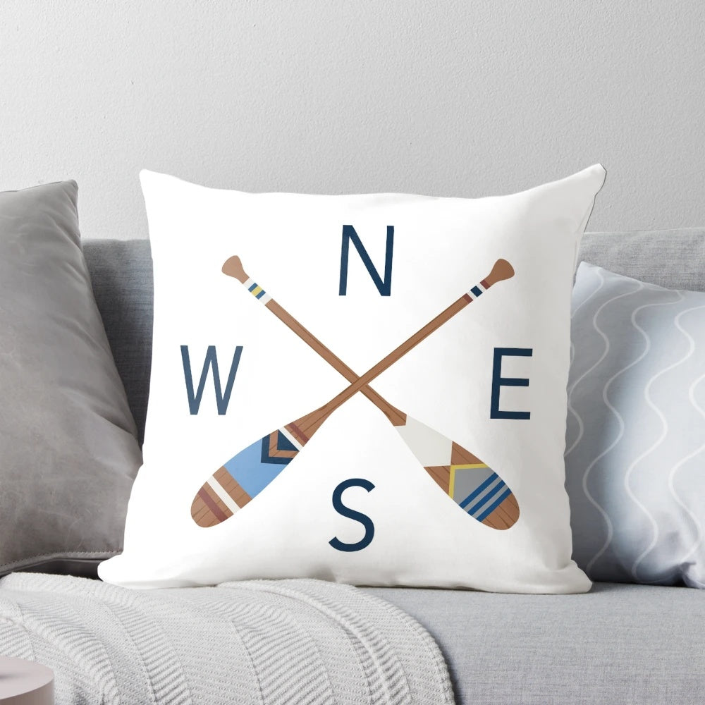 Rustic nautical compass and oar design printed on a cozy throw pillow, perfect for lake house, coastal, and boho-inspired home decor.