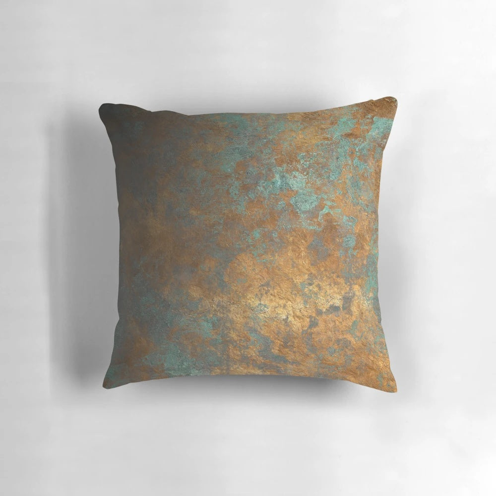 Oxidized copper pillow with a unique, metallic finish for a modern, industrial-inspired home.