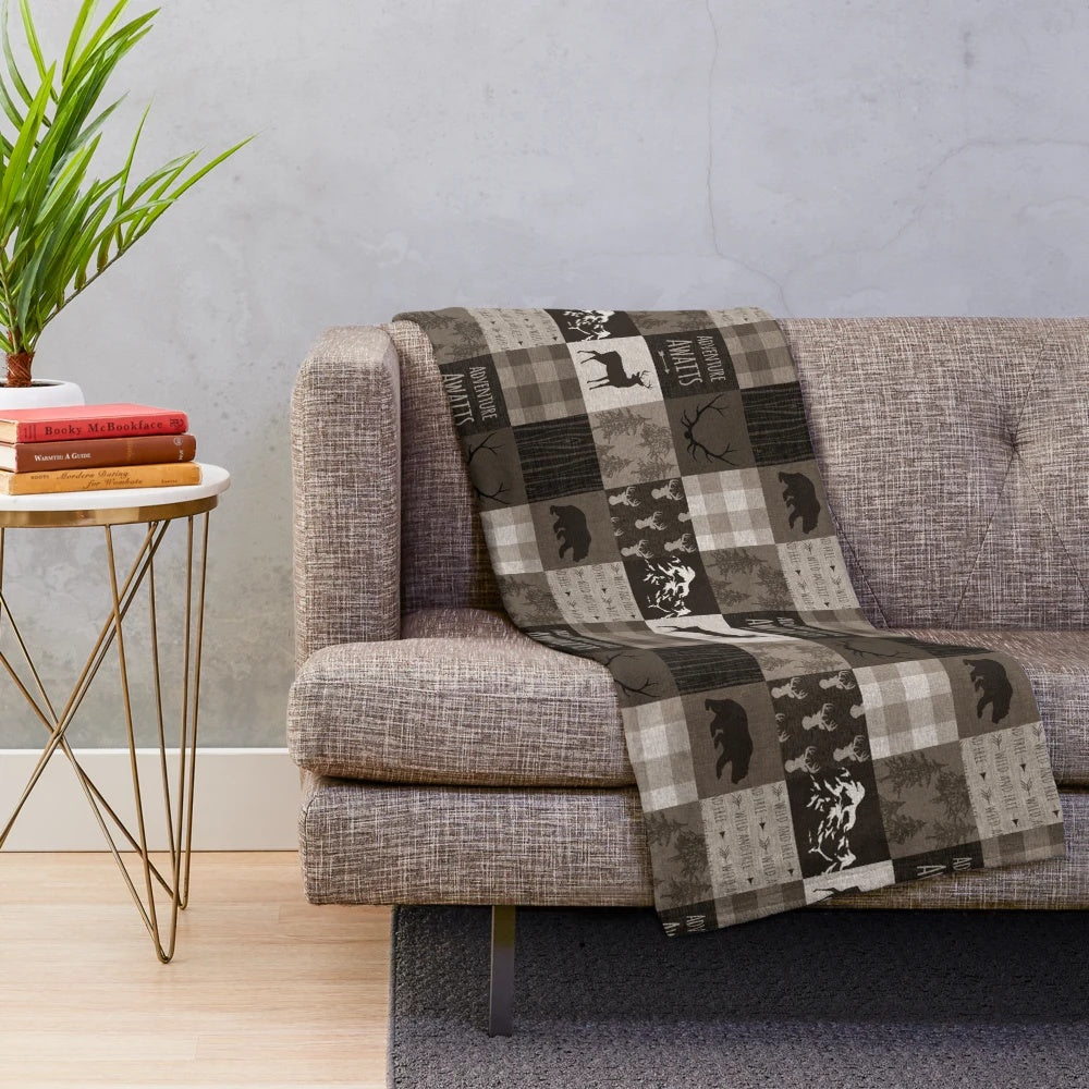 Rustic plush blanket with patchwork wildlife and adventure design