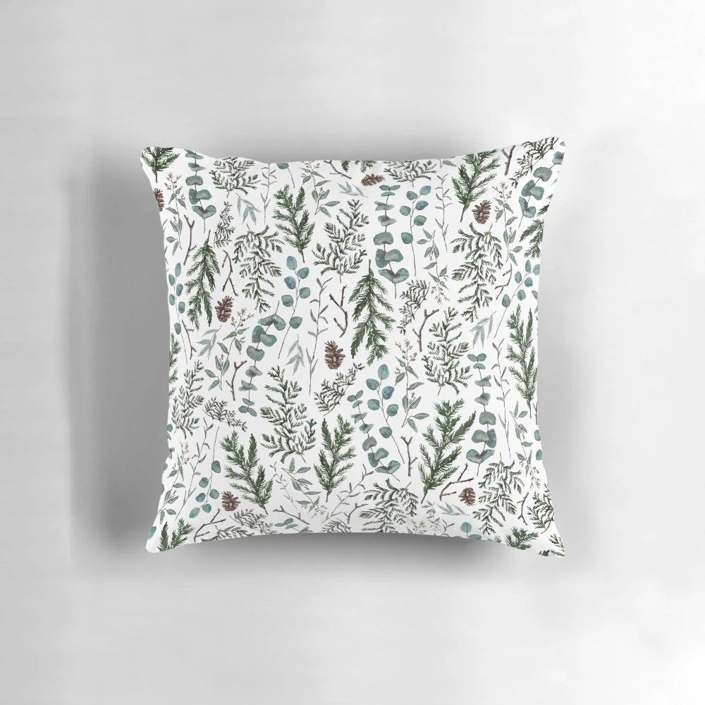 Cozy pine and eucalyptus pillow with watercolor foliage design