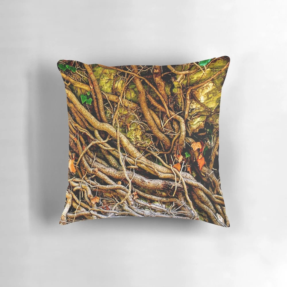 Closeup photo of a decorative pillow with a tangled vine design on a stone background
