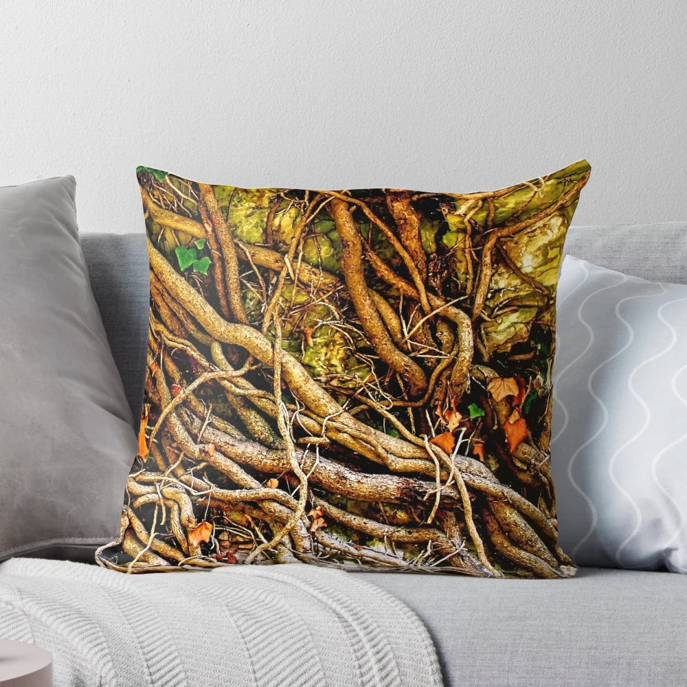 Closeup photo of a decorative pillow with a tangled vine design on a stone background