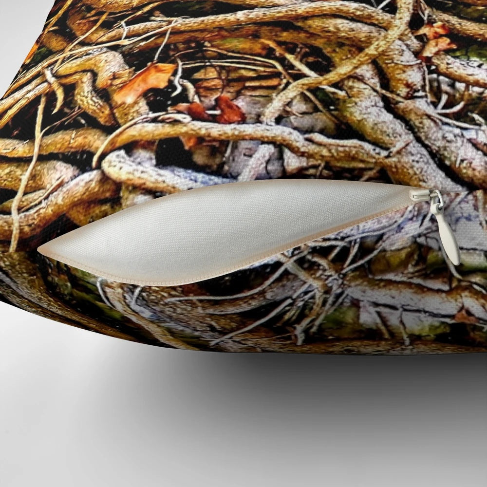 Closeup photo of a decorative pillow with a tangled vine design on a stone background