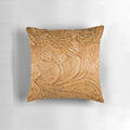 Closeup of a tooled leather pattern decorative pillow with a rustic southwestern style.