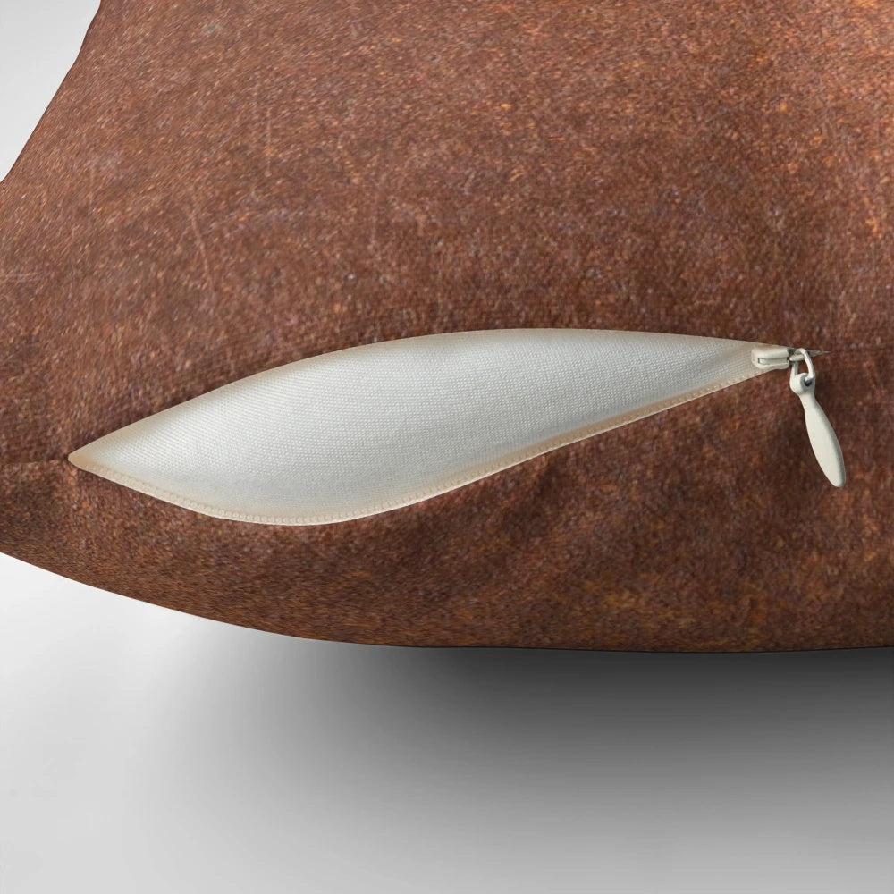 An old, rusty metal iron pillow with a textured, grunge-like surface