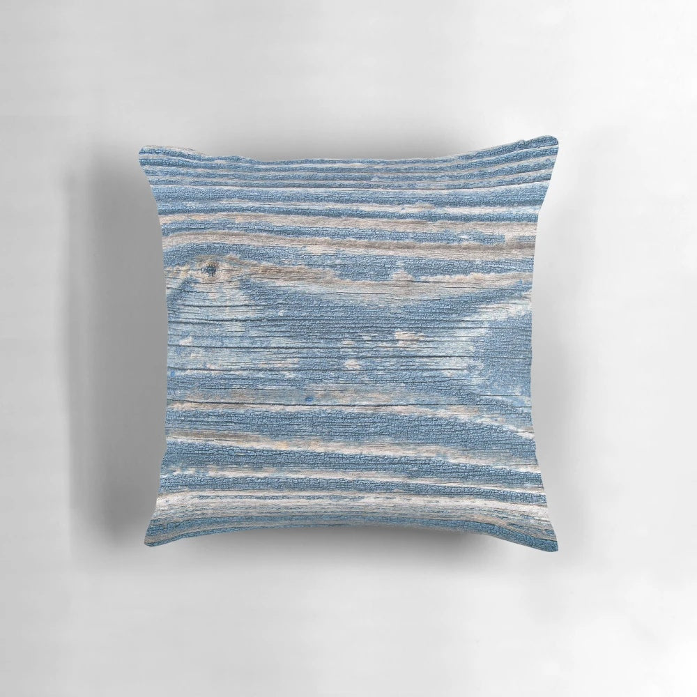 Rustic weathered wood effect pillow in blue tones, perfect for coastal and beach house decor