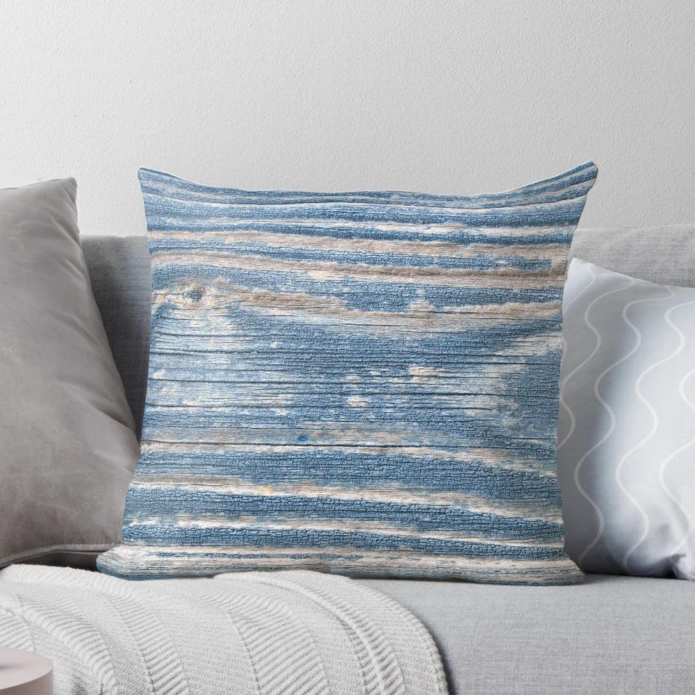 Rustic weathered wood effect pillow in blue tones, perfect for coastal and beach house decor