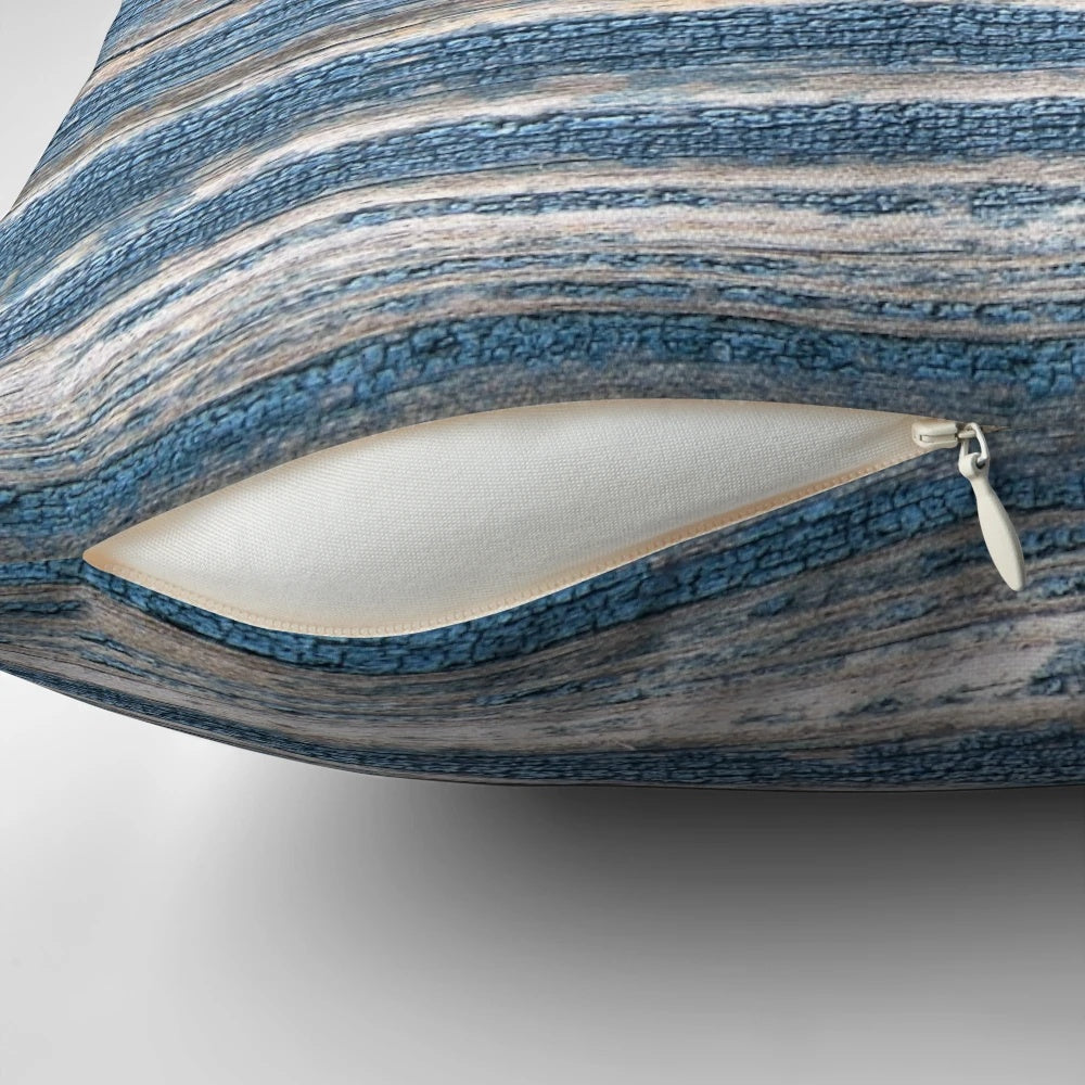 Rustic weathered wood effect pillow in blue tones, perfect for coastal and beach house decor