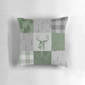 Rustic patchwork pillow with deer, trees, and arrow design in green and grey colors