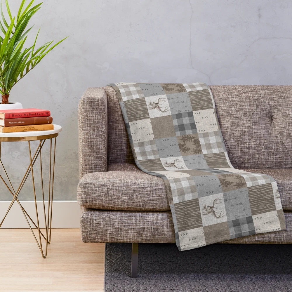 Rustic woodland patchwork plush blanket featuring deer design