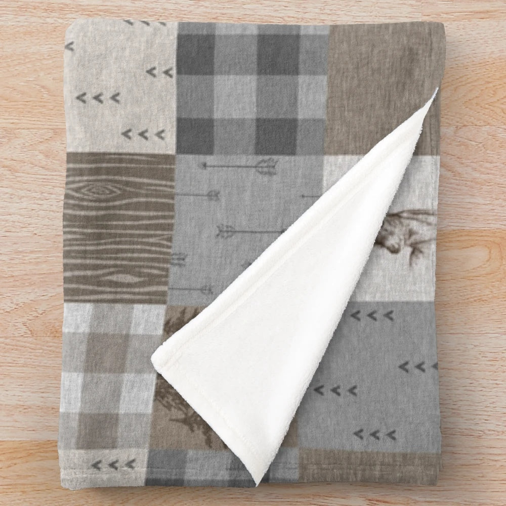 Rustic woodland patchwork plush blanket featuring deer design