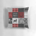 Rustic red and black patchwork pillow with woodland animal motifs, including moose, elk, and deer.