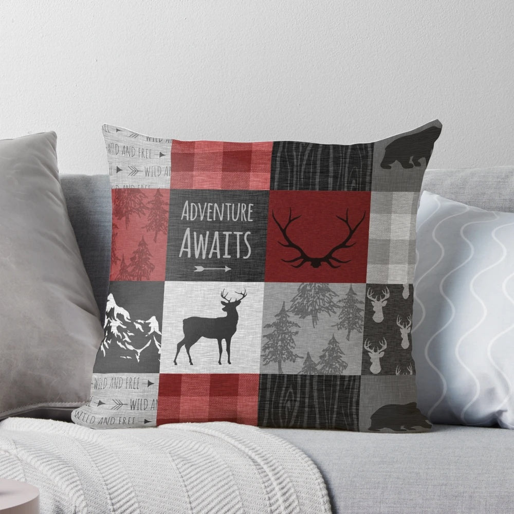 Rustic red and black patchwork pillow with woodland animal motifs, including moose, elk, and deer.
