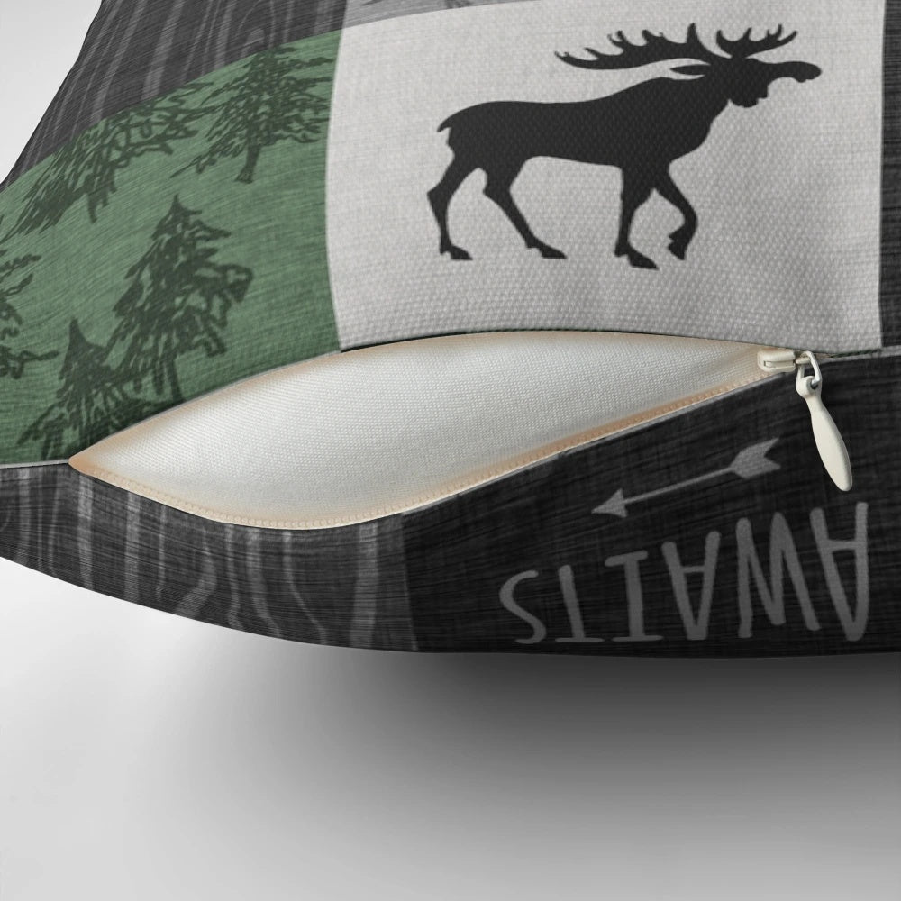 Rustic woodland patchwork throw pillow in shades of gray and green, featuring deer, moose, and other woodland elements.