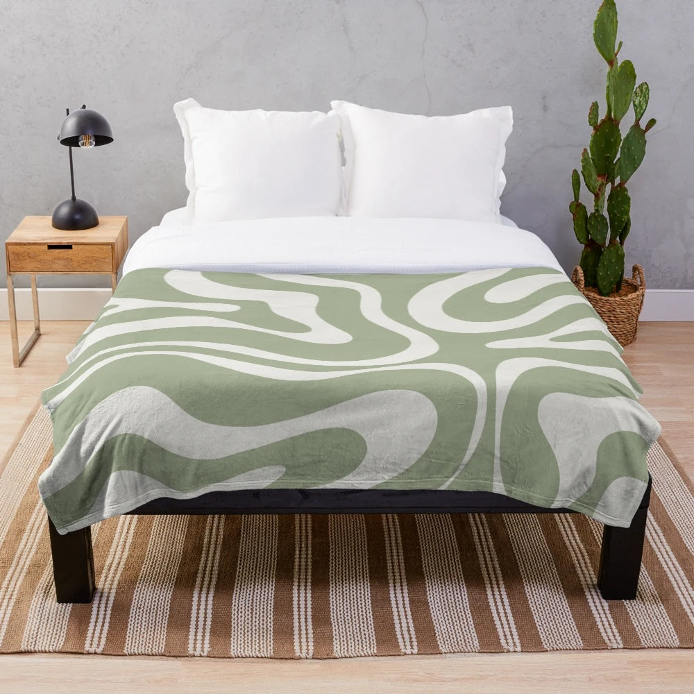 Sage green and white plush blanket featuring an abstract swirl pattern