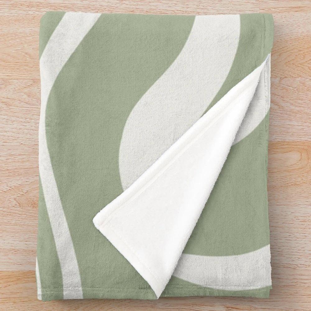 Sage green and white plush blanket featuring an abstract swirl pattern