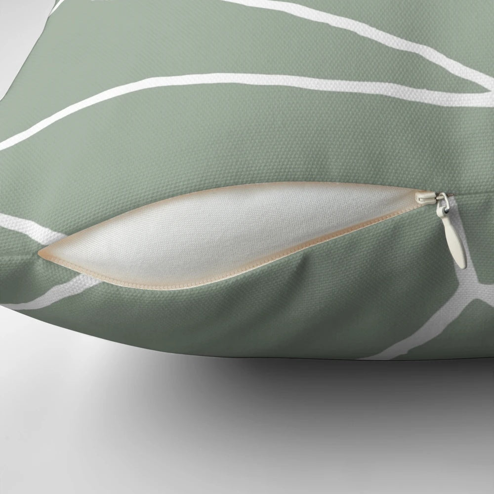 Sage green throw pillow with a geometric, minimalist design inspired by Moroccan patterns and tiles.