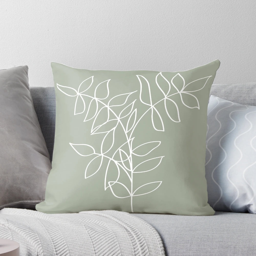 Sage green pillow with a minimalist plant line art illustration, ideal for boho and Scandinavian-inspired home decor.