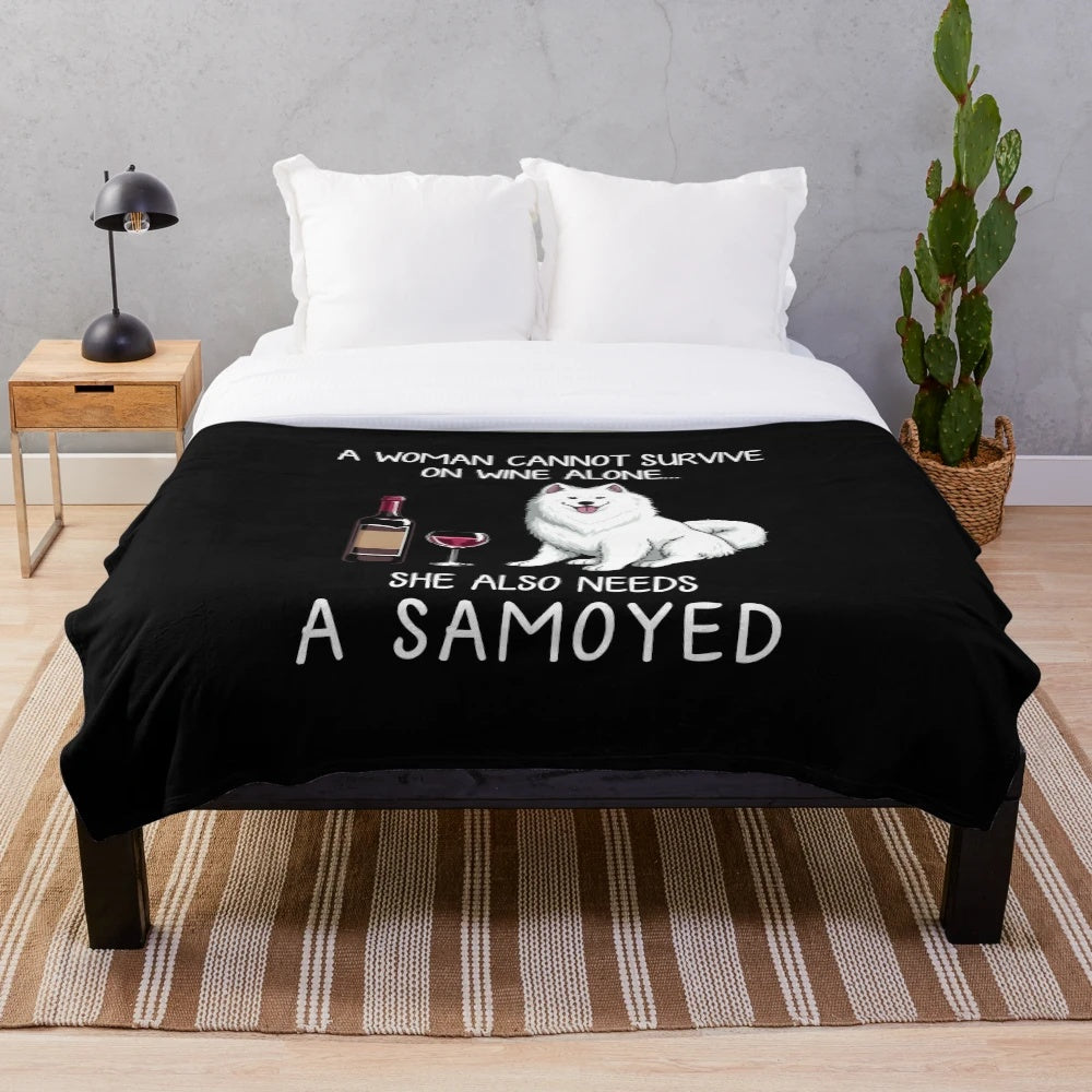 Samoyed dog with wine on a plush blanket