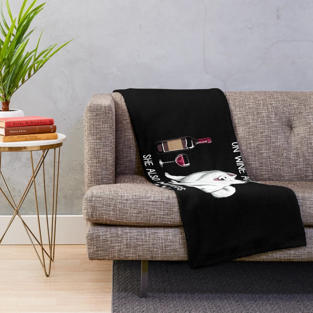 Samoyed dog with wine on a plush blanket