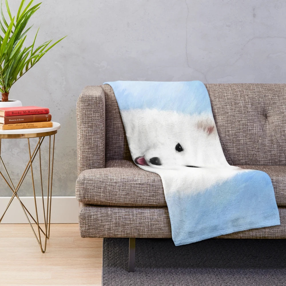 Samoyed puppy on a plush, white blanket