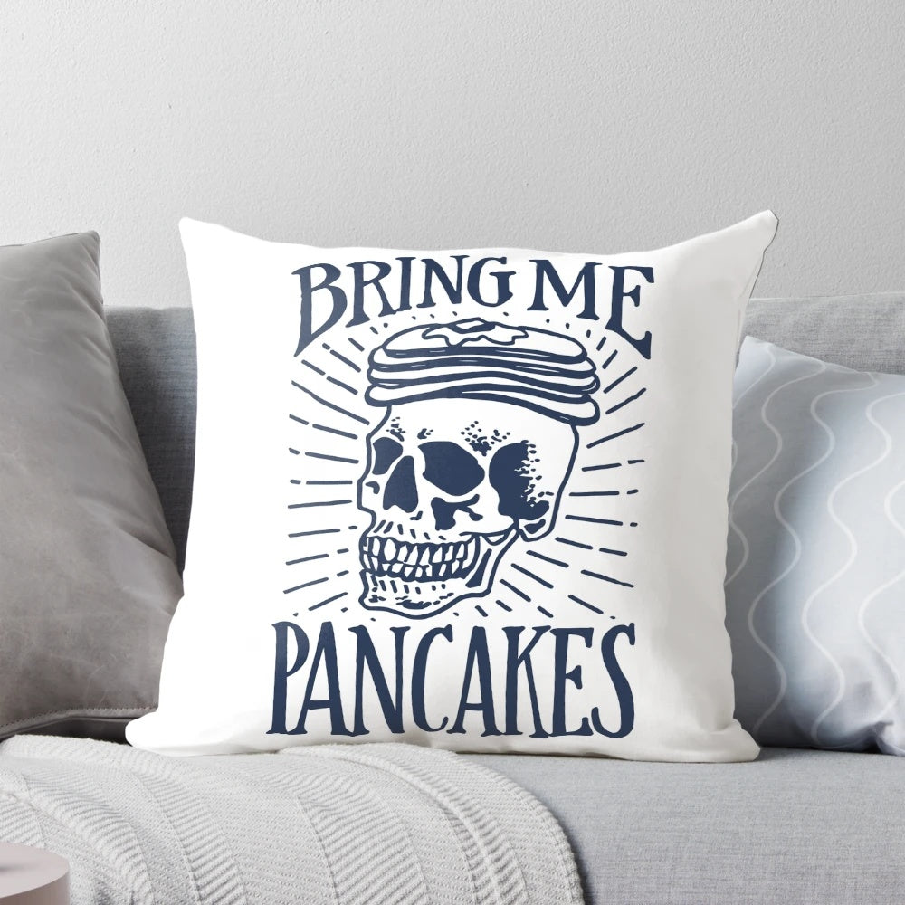 A sassy hand-lettered throw pillow with a skull and the text "Bring Me Pancakes