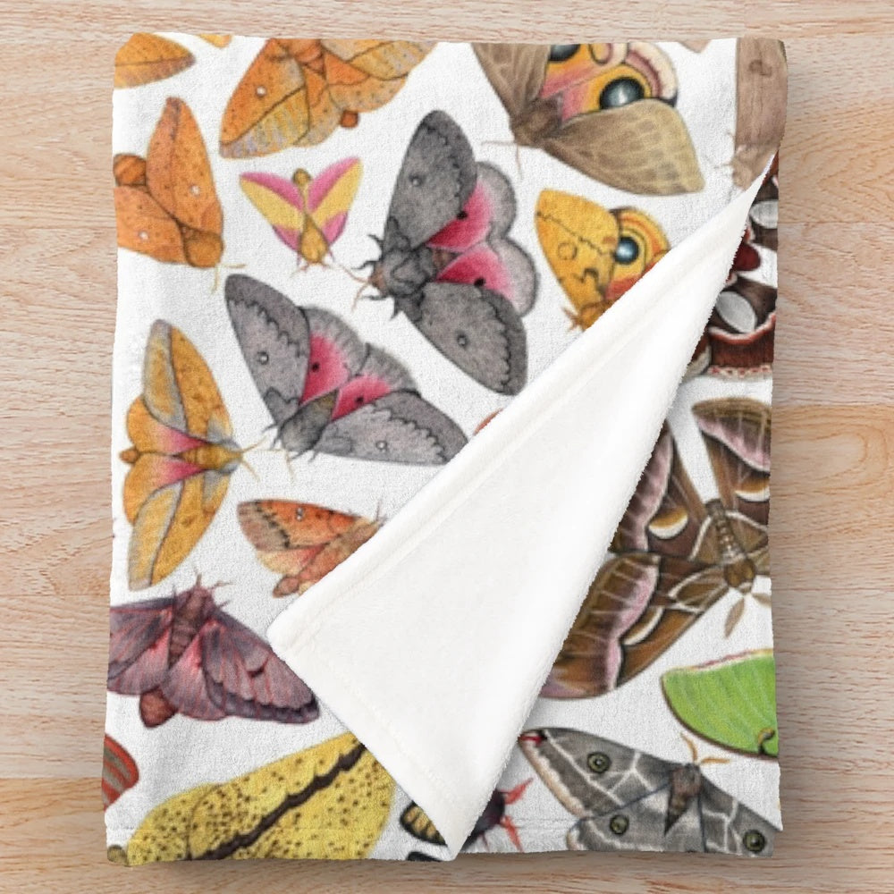 Soft plush blanket featuring a detailed illustration of saturniid moths from North America