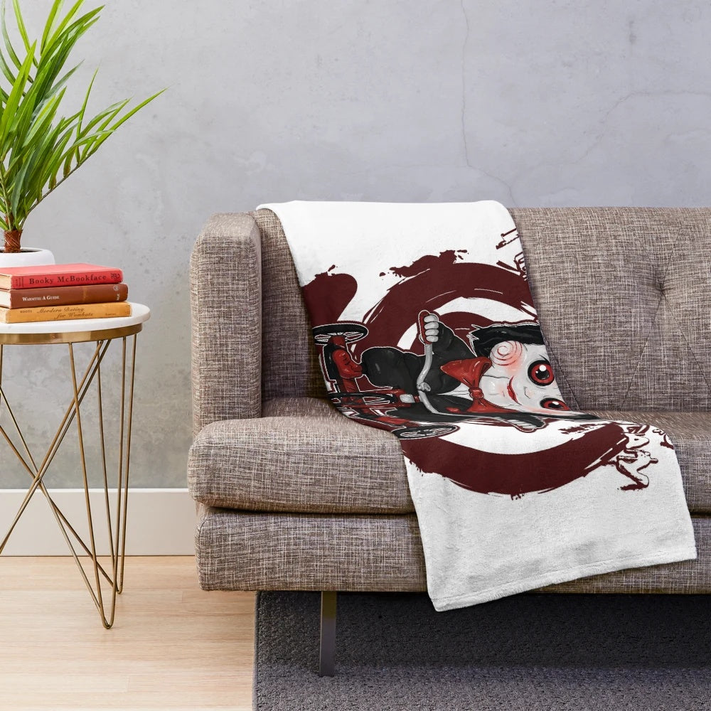 Saw-themed plush blanket with a kawaii tricycle design