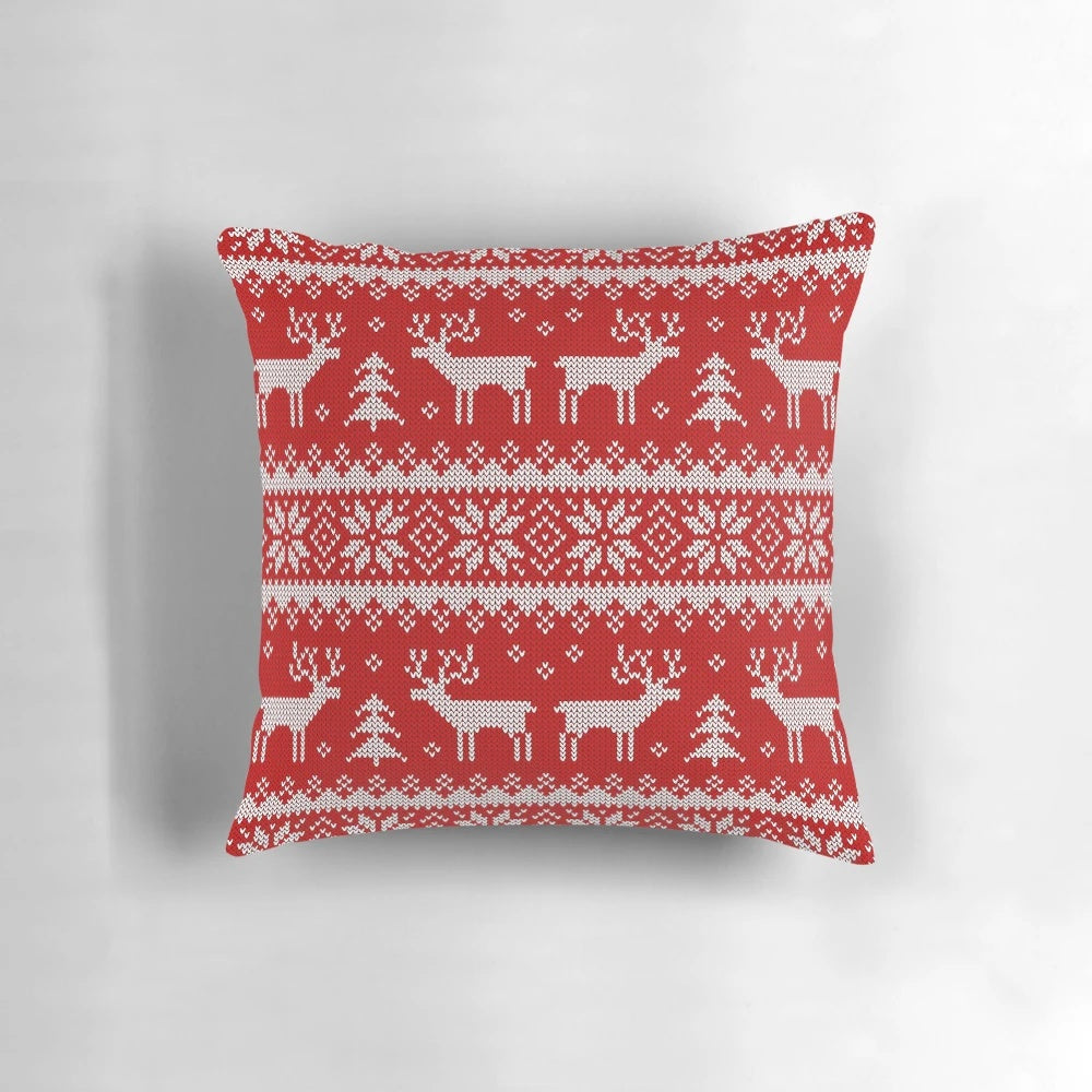 Pillow with a scandinavian-inspired pattern featuring deer and holiday elements in a cozy, winter-themed design.